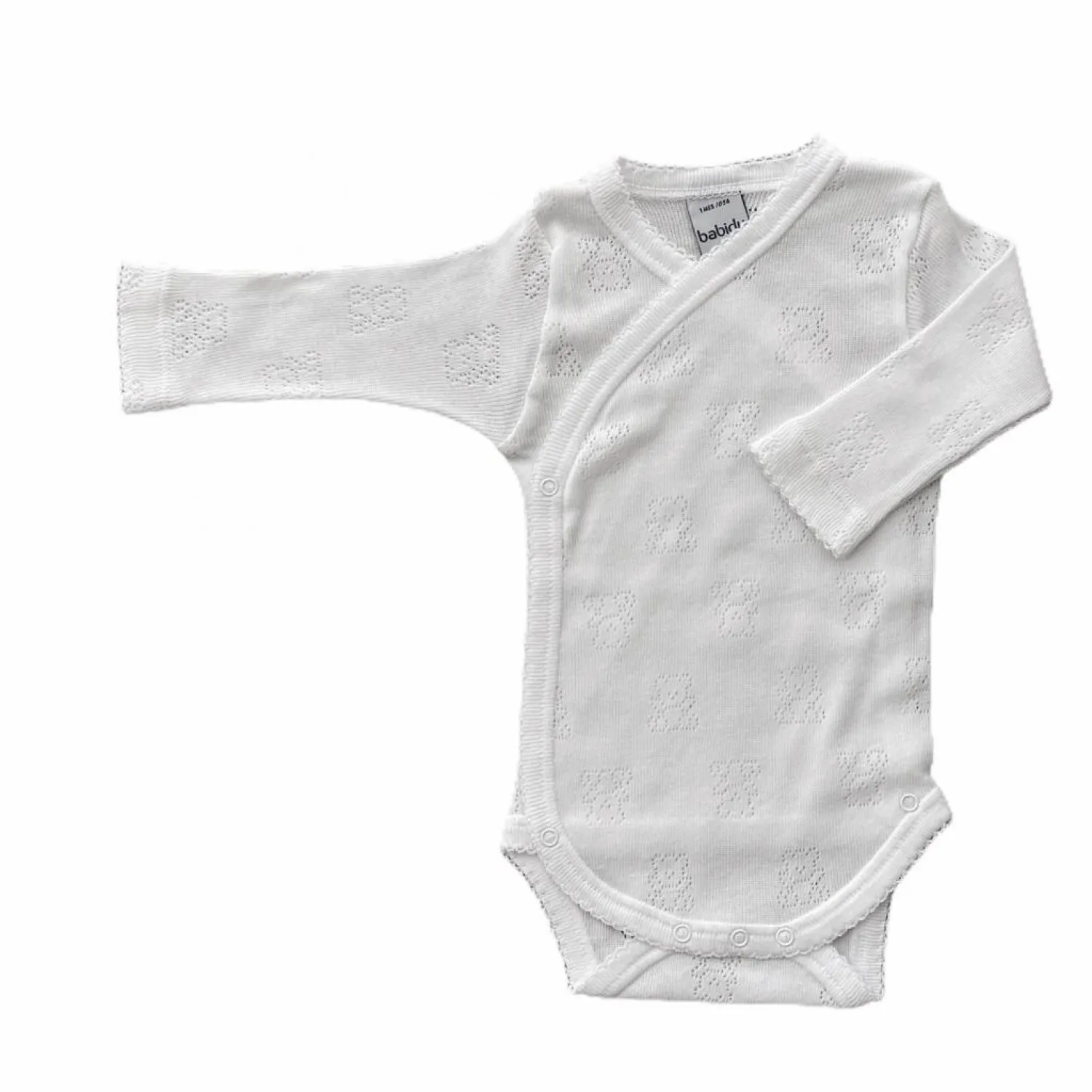 WHITE LONGSLEEVED BODYSUIT WITH OPENWORK BEARS.